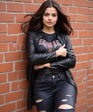 A hyper-realistic and highly detailed image of a 28-year-old indian  woman, flowing long wavy black-brown hair, big almond-shaped black eyes, with an hourglass figure and large bust, 

 exuding an edgy vibe in a black leather jacket over a fitted graphic t-shirt, paired with ripped skinny jeans. She leans against a brick wall with one leg raised, crossing her arms and looking confidently at the camera.