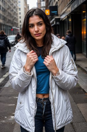  A frozen woman in her thirties on the street in a shabby modern down jacket with her hand outstretched. The woman pitifully and tearfully looks at the camera. Realistic photo