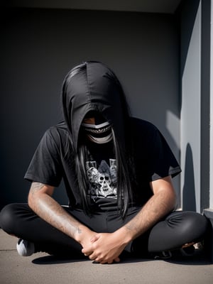  a young man (or teenager) kneeingbin a corner with his long black hair covering his face completely, as he would have done headbanging or is a death metal fan, showing up his two middle fingers