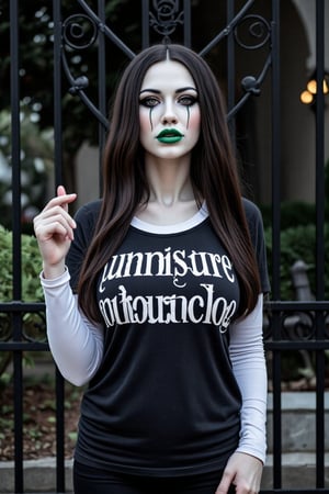 A 3D animated phantom woman stands in front of a black wrought iron gate. She is dressed in a black and white t-shirt with a white collar and long sleeves. Her hair is long and cascades over her shoulders. Her eyes are a piercing green, her lips are pursed in a neutral expression. Her left hand is raised in the air, her right hand resting on her hip. Her right hand is positioned to her right, adding a touch of green to the scene. A phantom halloween makeup in her face,Halloween makeup. White zombie color of her face. Green lips.