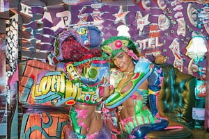 An award winning journalist Photograph, of a man and a woman wearing multi-colored inflatable outfits, in a funky love hotel having sexual intercourse, well lit cinematic lighting, complex shadows, extremely detailed , hotshoe flash on subject, text reads:"love hotel" , 1990s Photoshop style