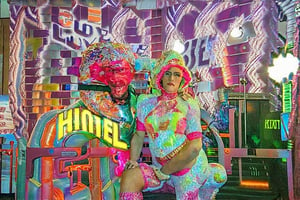 An award winning journalist Photograph, of a man and a woman wearing multi-colored inflatable outfits, in a funky love hotel having sexual intercourse, well lit cinematic lighting, complex shadows, extremely detailed , hotshoe flash on subject