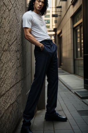 A realistic image of a young Asian man with long, wavy black hair, embodying the influencer persona. He has a slim body, dressed in a trendy outfit featuring trousers, a shirt, and a white t-shirt. The man poses confidently in front of a textured wall on a Seoul street, his gaze fixed on the camera. The composition captures his fashionable ensemble and the urban setting, with natural lighting accentuating the scene's authenticity.