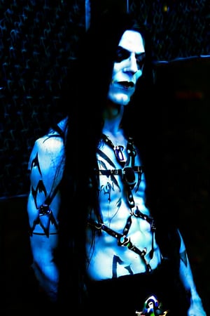 Black metal , metalhead  , male ,  creepy corpse paint , really thin eyebrows  , extremely long hair  , black metal outfit,   black skinny leather pants , tattoos,  facial piercings , ghost white skin,   black shirt, dark creepy dungeon bedroom,  