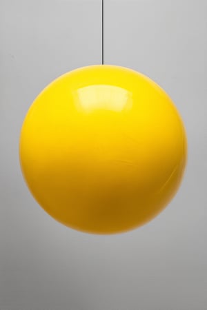 A vibrant yellow sphere, suspended mid-air, radiates warmth against a stark white background, with subtle gradations of tone and texture adding depth. Soft, diffused light casts a gentle glow, illuminating the subject's intricate details. Composition focuses on the central sphere, surrounded by negative space, emphasizing its primacy in the frame.