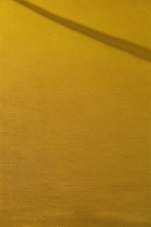 A vibrant yellow hue dominates the frame, a Basic Yellow Color Model unfolding like a warm ray of sunshine. Soft focus captures the gentle gradient of tones, transitioning seamlessly from bright cadmium to golden honey. A subtle shadow highlights the intricate texture of a textured surface, adding depth and dimensionality.