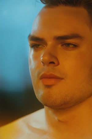 A close-up shot of Jero's face, lit by a warm golden light, with a hint of soft focus to emphasize his youthful features. His eyes are cast downward, a look of contemplation on his expression, as if lost in thought. The background is blurred, with a subtle gradient of blue tones, evoking a sense of serenity.