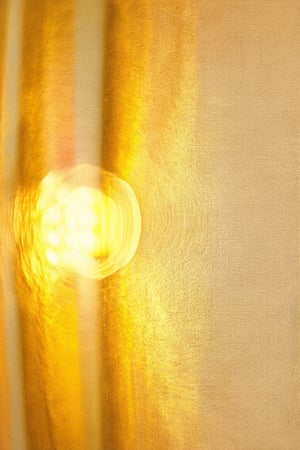 A close-up shot of a vintage-style color wheel, with warm light casting a golden glow on the yellow hues. The model, set against a soft focus beige background, showcases a bright and cheerful Basic Yellow, surrounded by subtle transitions to neighboring colors, highlighting its unique vibrancy.