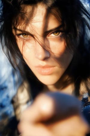 A close-up shot of a young woman's face, eyes blazing with determination as she raises her fist in defiance. Strong lighting casts sharp shadows on her features, highlighting the intensity in her gaze. Her dark hair is windswept, framing her face like a warrior's crown. The background is blurred, focusing all attention on this powerful expression of conviction and resilience.