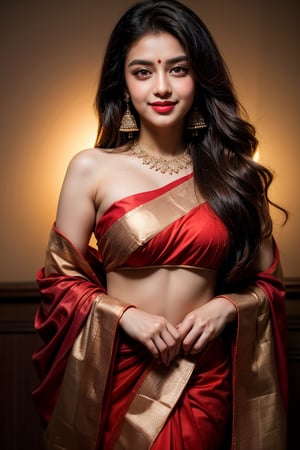 A woman, dressed in a vibrant red saree with intricate sequined borders, stands out against a dark, plain backdrop, highlighting the garment's bold color. Her long, straight hair falls to one side as she smiles softly, her traditional earrings and small bindi adding to the overall sense of cultural elegance. The composition is simple yet effective, allowing the beauty of the saree and the subject's subtle smile to take center stage.