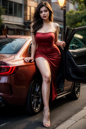 A sultry evening scene unfolds as a ravishing young woman stands poised beside a sleek, black sedan, her long legs crossed at the ankles and her slender fingers grasping the door handle. A stunning, strapless red dress hugs her curves, its hemline riding just above her knees, drawing attention to her toned calves and ankle-high stilettos. The traffic light overhead casts a warm, golden glow, illuminating her radiant complexion and striking features as she waits patiently for the signal to change.