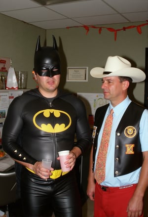 Middle-aged man wearing a cheap Batman costume. Film grain adds an edgy grit to this award-winning shot.