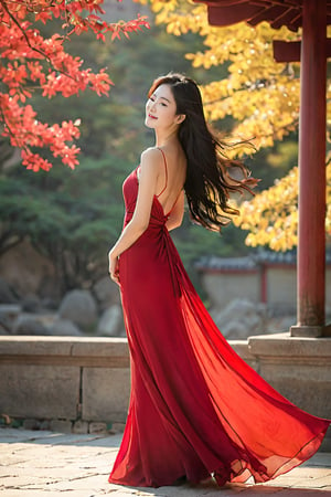 A serene afternoon setting: a stunning Korean woman stands effortlessly in a breathtaking long red dress, her raven locks cascading down her back. The warm sunlight illuminates her slender figure, accentuating her elegance as she wears an enigmatic smile. The atmosphere is alive with a gentle breeze and whispering wind, captured in a photorealistic image that exudes refinement.