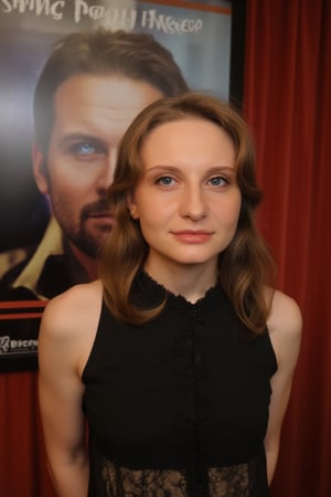  A young woman ufil5 stands confidently against a movie poster backdrop, her gaze directed straight at the camera, exuding an air of confidence and allure, She wears a black top with a lace pattern, her features softly highlighted by even lighting, Off-center placement draws the viewer's eye towards her, while a subtle hint of a man in the background adds depth to the scene, The movie poster suggests a possible movie theater setting, 