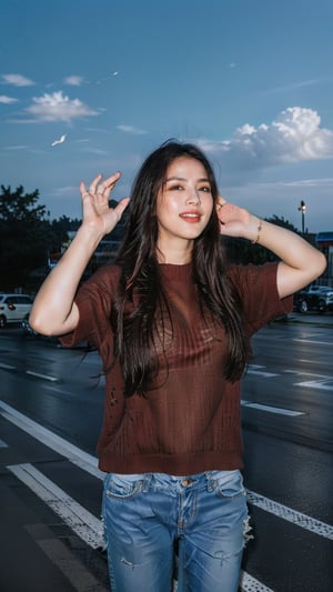 A solo indian female figure stands confidently outside, her long brown hair blowing gently in the breeze. She gazes directly at the viewer with a warm, radiant smile, her teeth gleaming in the sunlight and her face seems extremely realistic. Her outfit is casual yet stylish, featuring an orange sweater and jeans, accented by jewelry around her neck and looking extremely realistic. Her hands rise above her head, palms up, as she exudes a sense of freedom and joy. The blurred background adds to the dreamy atmosphere, while her sharp features remain crisp and extremely realistic.