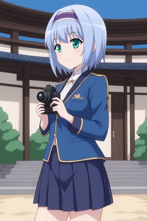 Linze, the anime girl with short, silver-blue hair and emerald green eyes, is on a school trip to a historical site. She is wearing casual travel attire: a white blouse with a light blue jacket and a navy blue skirt. Linze is taking photos with a camera, standing in front of a traditional Japanese temple or historic landmark. The scene includes other students and the cultural site, with clear skies and a pleasant atmosphere.
