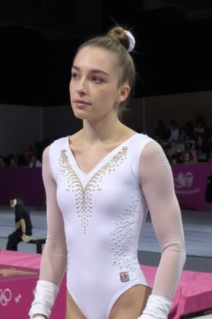 A  photograph of evamos wearing white gymnastics uniform, in an olympics event. Foreground. 