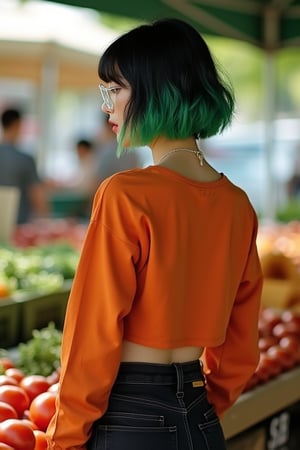 A young woman, vaguely Korean, has short wavy black hair, cut into a bob haircut and dyed with a neon green ombre; she is thin and bony and she dons baggy burnt orange long sleeve crop top, and high-waisted black skinny jeans. She wears feminine clear plastic glasses and has a soft, round face.
We see her from the side as she stands in front of us picking up tomatoes at a booth at an outdoor farmers market