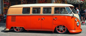 THERE IS A KOMBI STATION WAGON ,(RED METALLIC PAINT,orange,white , SPORT wheel variations, with blackVOLKSWAGEN PARKING, Carrinha, Bullies, Carrinha, Driving a VW van, Kombi VW on a street, profile picture, esquema de cores orange e branco, vibe vintage, 4 0 9 6, well it, 1959, Campista, hippie, Vindima - W 1 0 2 4, visual vintage, cartoonish, comic strip, Chip Foose car rendering, chrome wheels, bagged, slammed to the ground, masterpiece