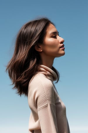 Ashley's profile emerges against the brilliant blue sky, her long hair blowing gently in the breeze as she stands alone, dressed in a soft pink sweater dress. Framed by the vast expanse of clear blue, her figure is set against a minimalistic backdrop, emphasizing simplicity and elegance. The natural composition showcases Aishi's serene pose, inviting the viewer to step into the dreamlike atmosphere.