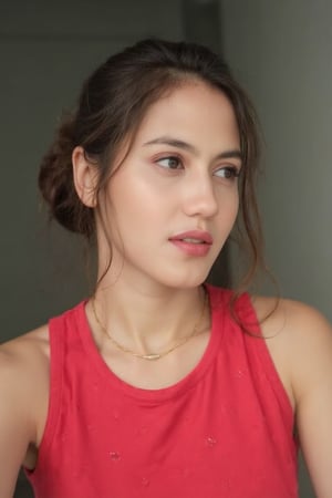 An image of a young woman with a soft, natural complexion and a low bun hairstyle, featuring loose strands of hair on the right side of her face. She poses semi-profile, facing slightly to the right, with her gaze meeting the camera. She wears a sleeveless red top with a small white dot pattern and a delicate gold necklace. The lighting is soft and natural, accentuating her thoughtful expression, against a softly blurred background.,pevit4