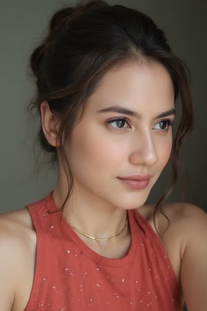 An image of a young woman with a soft, natural complexion and a low bun hairstyle, featuring loose strands of hair on the right side of her face. She poses semi-profile, facing slightly to the right, with her gaze meeting the camera. She wears a sleeveless red top with a small white dot pattern and a delicate gold necklace. The lighting is soft and natural, accentuating her thoughtful expression, against a softly blurred background.,pevit4