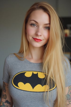 A close-up photo of a 30yo Su1c1de_G1rls woman with very long blonde hair. She has a cute round face with freckles, body covered in tattoos, red lipstick, red painted nails, and smiles. She is wearing a skin-tight fitted graphic T-shirt made from smooth stretch fabric with a yellow Batman logo. 