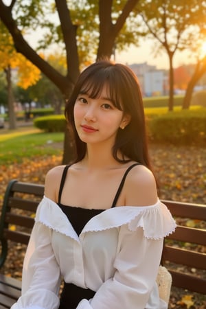 BaeSuzy wearing white shirt sits on a bench, bathed in warm, golden light, her expression serene and thoughtful. She wears a black, off-shoulder top and skirt, blending into the soft autumn background with blurred trees and glowing leaves. Her dark hair frames her face, complementing the calm, introspective mood of the scene.,