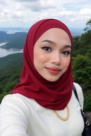 This is a high-resolution photograph featuring a young woman taking a selfie at an elevated viewpoint, likely a lookout or skywalk. The woman is of South Asian descent, with fair skin and a round face adorned with meticulously applied makeup, including bold, winged eyeliner and matte lipstick in a deep red shade. She wears a white, long-sleeve ribbed knit sweater ((extra tight)) and a voluminous, rich red hijab that flows gracefully around her, covering her head and shoulders. 

Her hijab is made of a lightweight, sheer fabric that allows for a soft, delicate texture contrasted against the knit sweater. She has a confident smile and is looking directly at the camera, capturing the moment with her right arm extended.

In the background, the scene extends to a breathtaking panoramic view of lush green forested hills and a vast body of water, likely a sea or lake, under a partly cloudy sky. The horizon is distant, with faint outlines of distant islands and the coastline. The overall mood of the image is serene and picturesque, highlighting both the beauty of nature and the woman's elegant attire.