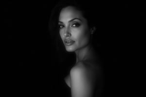 Black and white portrait of Angelina Jolie, dark background, shadow play, soft lighting, cinematic style