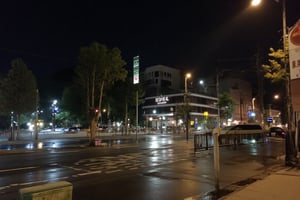 Photo taken from the glass window of the room facing outside with a view of heavy rain. This photo was taken right at night