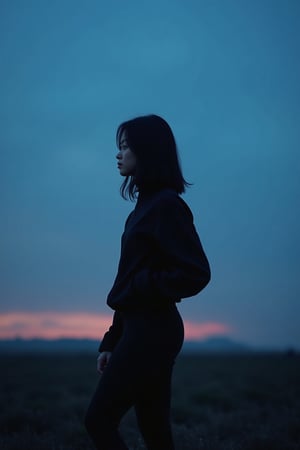 An additional long shot landscape photo showing a profile of a young Asian woman standing in front of a dark blue sky at dawn. The woman is wearing black leggings tracksuit with black hair. The entire image shows a minimalist and dreamy style.