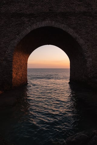 stylized by Suehiro Maruo and Frits Van den Berghe, [photograph, hip level shot of a The ancient portal of San Francisco comes alive with the glow of a glowing red light. In the center of it all, a small stone bridge made out of smooth stones stretches towards its shore. As the sun sets in the distance, we see a faint orange hue that illuminates the sky. The water reflects the soft light, creating a peaceful and serene scene. at Golden hour, Wide view, Magical, film grain, Canon eos 5d mark 4, Fish-eye Lens, Film grain::14], , , , creative, very coherent, cinematic perfect intricate stunning fine detail, highly detail, highly contrasted, enhanced quality, badge, contemporary, delicate, aesthetic, dynamic background, intricate