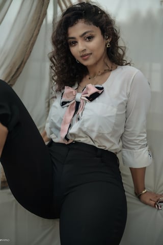 (best quality,4k,8k,highres,masterpiece:1.2),ultra-detailed,(realistic,photorealistic,photo-realistic:1.37),portrait, mid-twenty woman, 32 years old, black pants, medium dark red bob hair, fair skin, red eyes, soft pink lips, curvy, hourglass-shaped figure, large huge breasts, soft lighting,Mallu curly hair, black pants, o-neck shirt, bow blouse casual, full sleeve tshirt 
