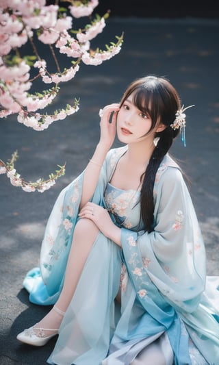 a woman in a blue period dress sitting on the ground,traditional attire,hanfu,cherry blossoms,serene expression,seated pose,ethereal lighting,black background,flowing fabric,reflective surface,high contrast,gentle gaze,soft makeup,pastel colors,blurred petals falling,cultural,fantasy ambiance,elegance,grace,historical costume,fabric draping,photoshoot,artistic composition,side lighting,blue gradient dress,tranquil atmosphere,delicate accessories,hair ornaments.,arien photography,sexyling54894416