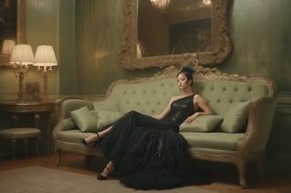 A woman reclining elegantly on a beige, vintage-style bench in an opulent room. She wears a shimmering black dress adorned with sequins and has a feathered accessory draped over her left shoulder. The room features a lavish fireplace with intricate carvings, and the walls are painted in a soft green hue with gold accents. A large mirror hangs above the fireplace, reflecting the room's grandeur.