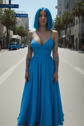 A 23-year-old American woman with blue hair and no tattoos in a Hollywood street full of people in a beautiful blue dress.