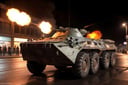 analog gloomy photo of a black eight wheeler (BTR-80, <lora:btr80:1>), racing down a neon city avenue at night,  shooting, buildings on fire, outrun, explosions in the background, High Detail, Sharp focus, ((photorealism)), realistic, best quality, 8k, award winning, dramatic lighting, epic, cinematic, masterpiece, dutch angle, ambient fog:1.4, volumetric lights, 