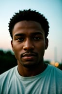 lifestyle photography photo of a black man, anticipate facial expression, close up on face, under soft lighting, high angle, shot on a Fujicolor Pro