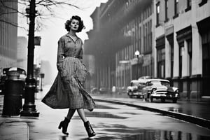 B & W Photo of a 20yo woman wearing a 1957 plaid shirtwaist dress, long cardigan, walking on wet pavement. Style by J.C. Leyendecker. Canon 5d Mark 4, Kodak Ektar