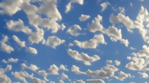 White clouds moving in a light blue sky, very luminous, 8k, realistic 