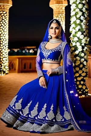 Create an image of a woman wearing an elegant Ghagra Choli paired with a matching hijab. The Ghagra Choli should be in a deep royal blue with intricate silver embroidery. The hijab is neatly styled and also features delicate silver embroidery along the edges. The setting is a softly lit outdoor evening event with ambient lighting and floral decorations in the background