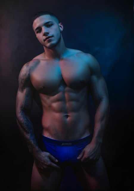 <lora:Jordan_Torres-v1:0.5> jordan_torres <lora:sc_brandon_v1-rugged:0.5> sc_brandon <lora:Studio_lighting:.7> Studio lighting, low saturation, (red and blue lighting), grey background, realistic Photo of a young man, bulge, muscular, dark, close up portrait, high detail, realistic, high detail, 8k, (Masterpiece, high quality:1.3), masterpiece, depth of field, bokeh, detailed, homoerotic, (homoerotic), highly detailed, sharp focus, intricate, smooth, elegant, fantasy, masterpiece, matte, photorealistic, 4k, beautiful,