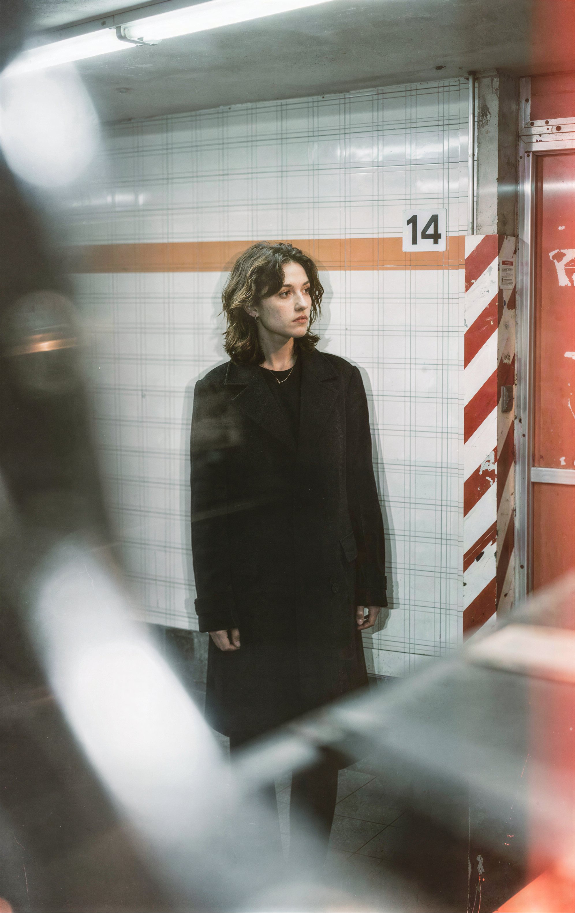 photograph of a young woman with light brown,  shoulder-length hair standing in a dimly lit,  tiled subway station by Synt...