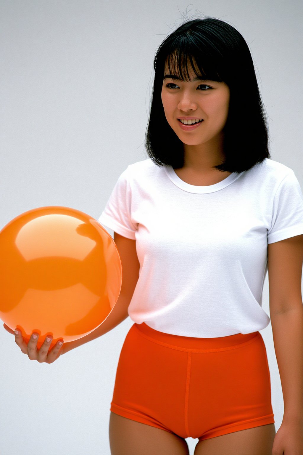 Japanese color film photograph of an Asian woman standing against a plain white background. She has straight,  shoulder-le...