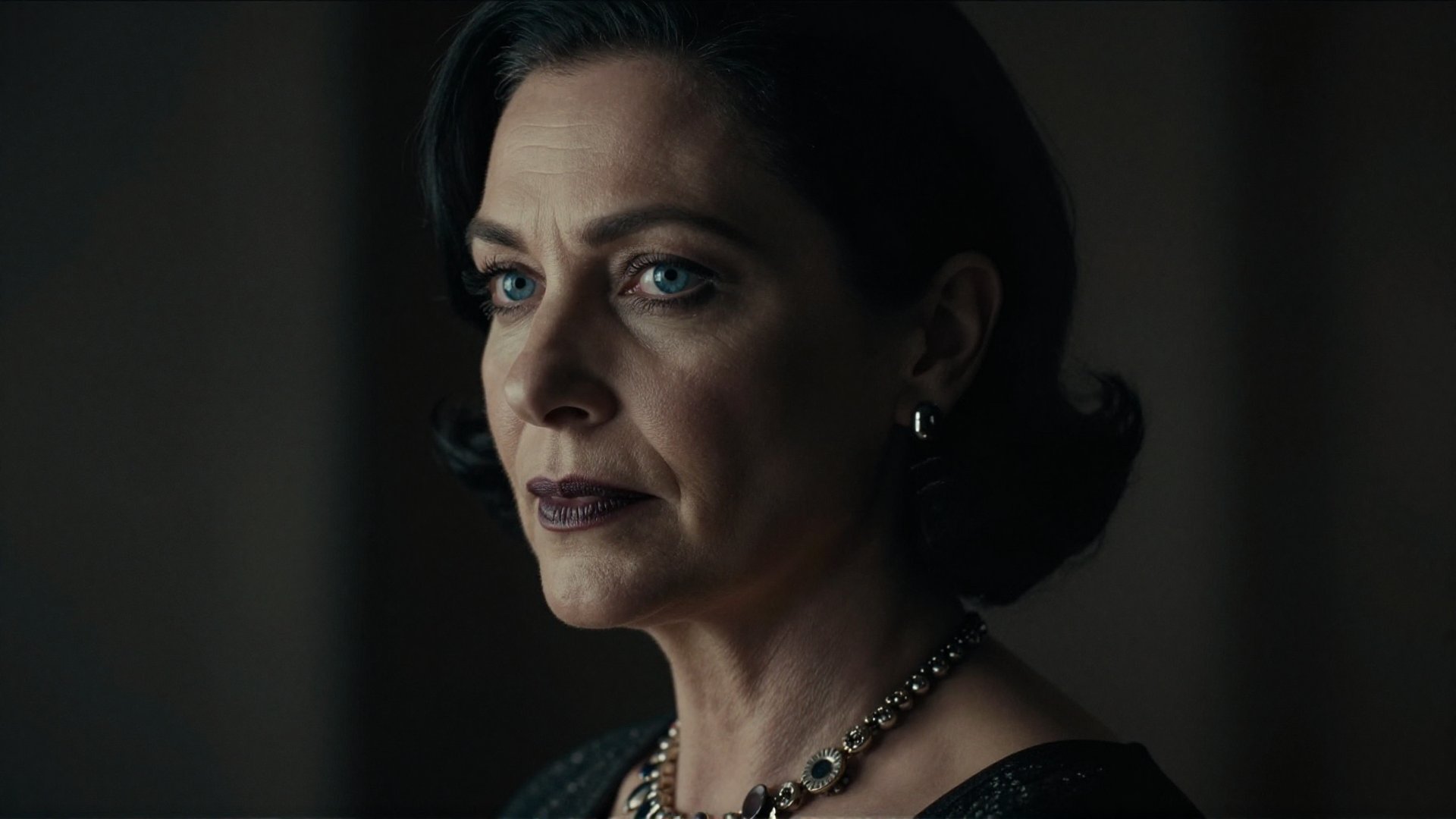 cinematic film still of Alcina Dimitrescu a closeup of a mature staring woman with a necklace on her neck,  perfect image,...