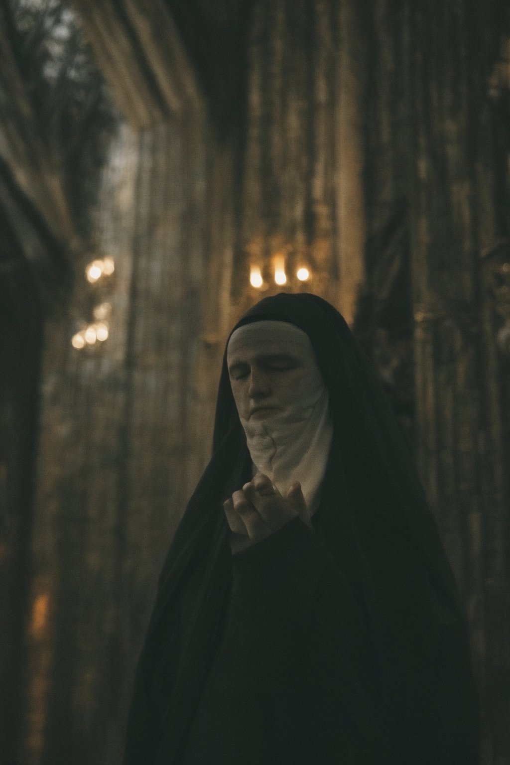 Close-up of a nun praying with her eyes closed inside a Medieval church. by MacrossManiac on Tensor.Art