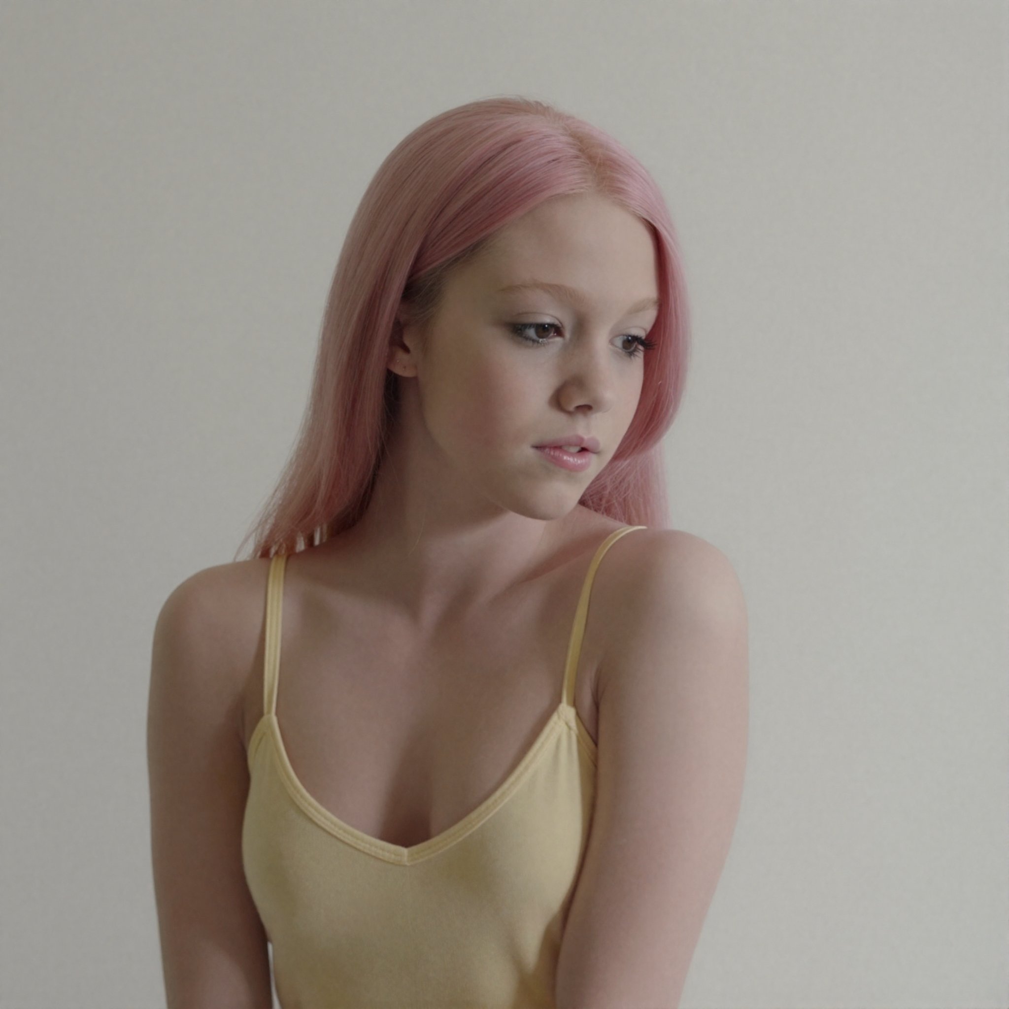 The image depicts a young teen with an unnervingly slender build and an elongated head-to-body ratio that accentuates her...