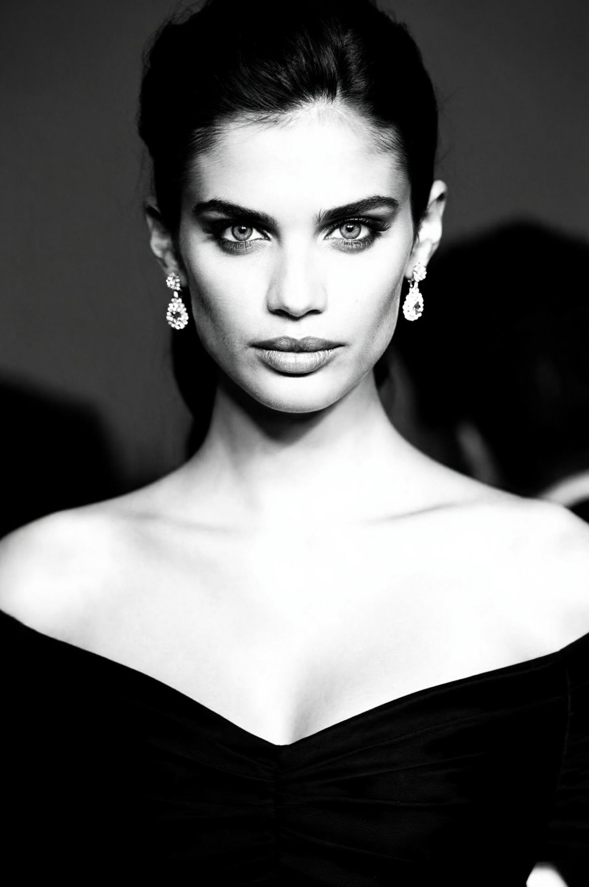 SUBJECT: woS4I0,  brunette model with striking eyes and defined cheekbones CLOTHING: elegant off-shoulder black dress ACCE...