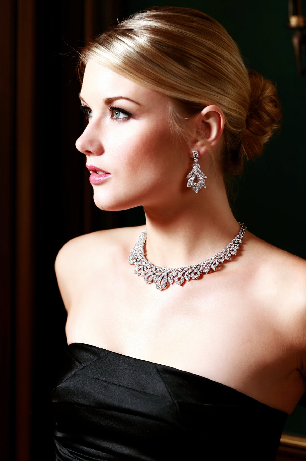SUBJECT: wpJ33l,  blonde woman with flawless complexion and graceful features CLOTHING: black strapless evening attire vis...